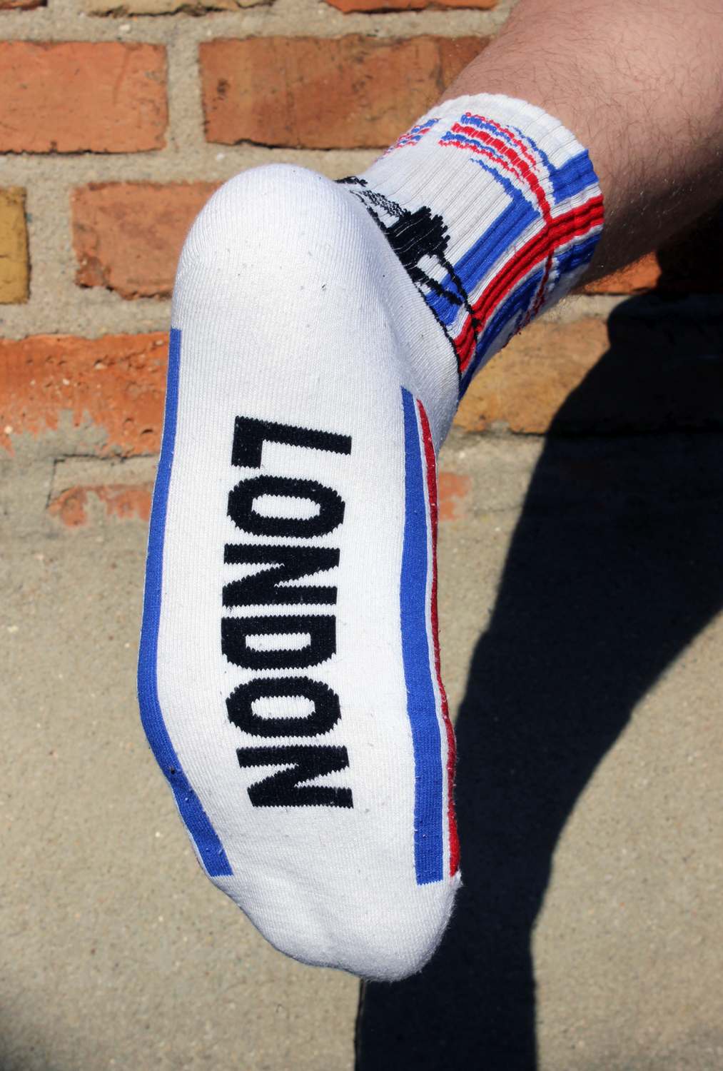 junger gay mit sk8erboy london socken mit union jack flagge am bund und big ben mit tower bridge mit extra grossem logo und schriftzug auf der unterseite der socken